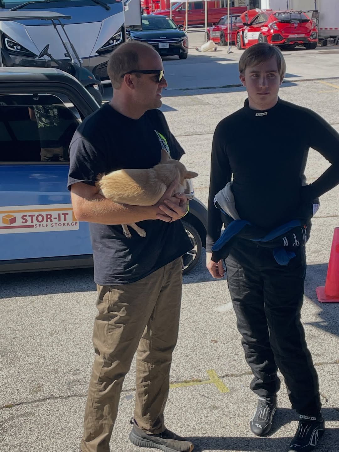 Will and Franklin Futrelle together in the paddock; one holds a small dog.